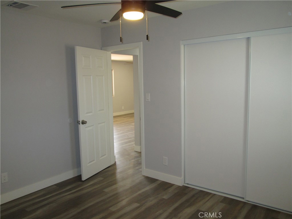 13464 Mohawk Road Apple Valley, CA 92308 - Photo 24 of 35 an empty room with wooden floor and closet