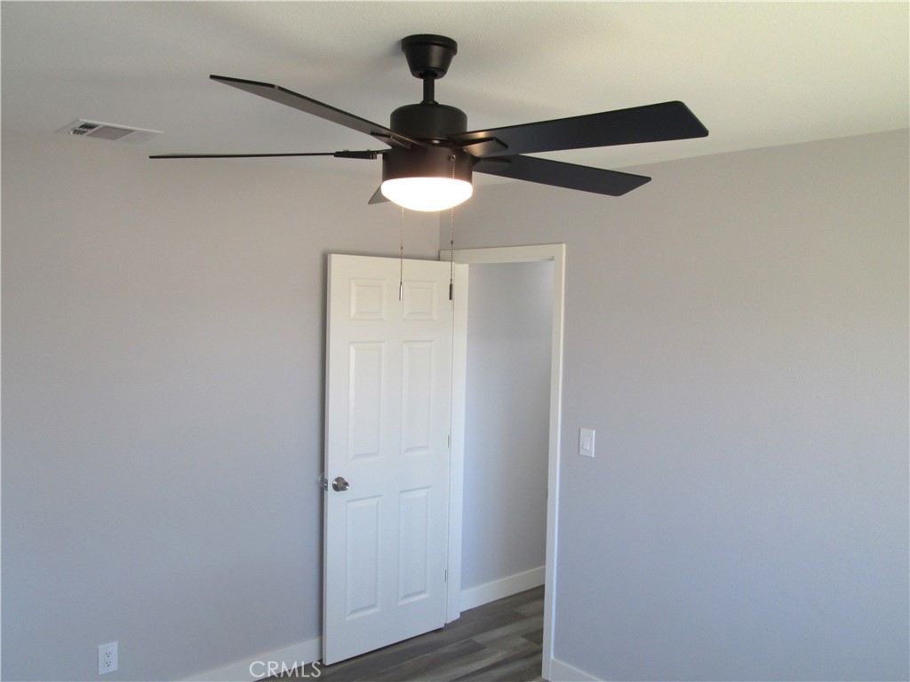 13464 Mohawk Road Apple Valley, CA 92308 - Photo 25 of 35 a light wood floor in a empty room