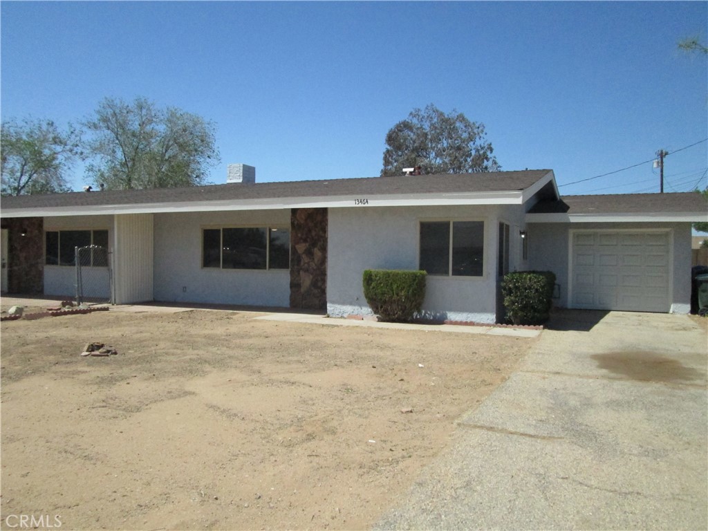 13464 Mohawk Road Apple Valley, CA 92308 - Photo 31 of 35 a view of a house with a yard and potted plants