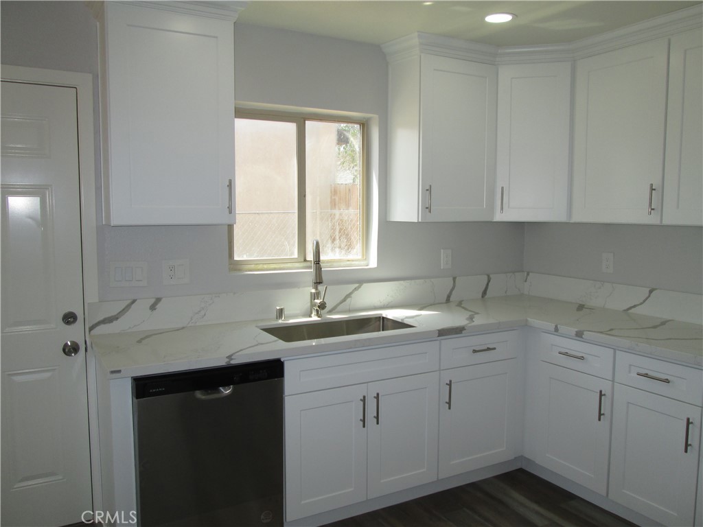 13464 Mohawk Road Apple Valley, CA 92308 - Photo 4 of 35 a kitchen with a sink dishwasher window and cabinets