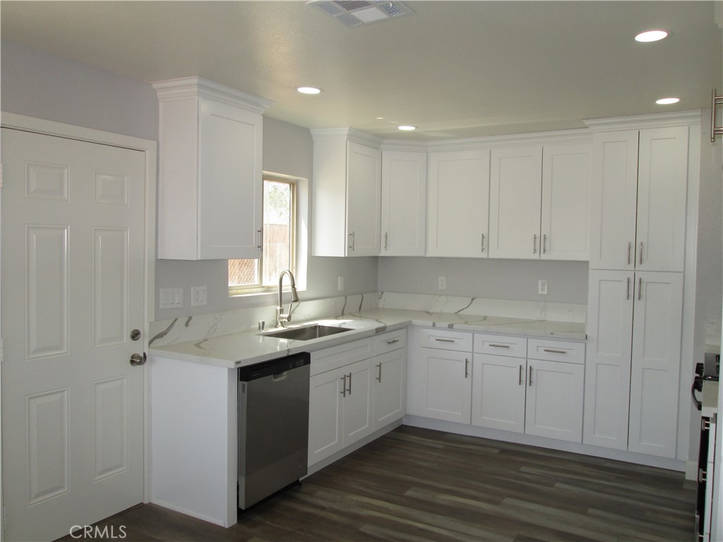 13464 Mohawk Road Apple Valley, CA 92308 - Photo 5 of 35 a kitchen with a sink cabinets and wooden floor