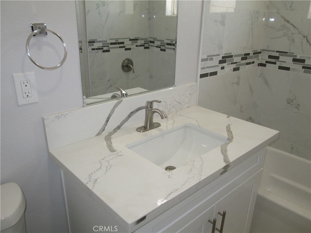 13464 Mohawk Road Apple Valley, CA 92308 - Photo 9 of 35 a bathroom with a sink a toilet and shower