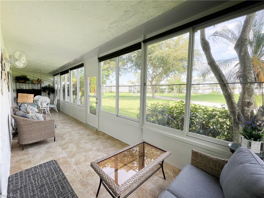 189 Harrison Road, Unit 111 Naples, FL 34112 - Photo 14 of 29 Huge glassed-in lanai with tile floor and view to 10th hole