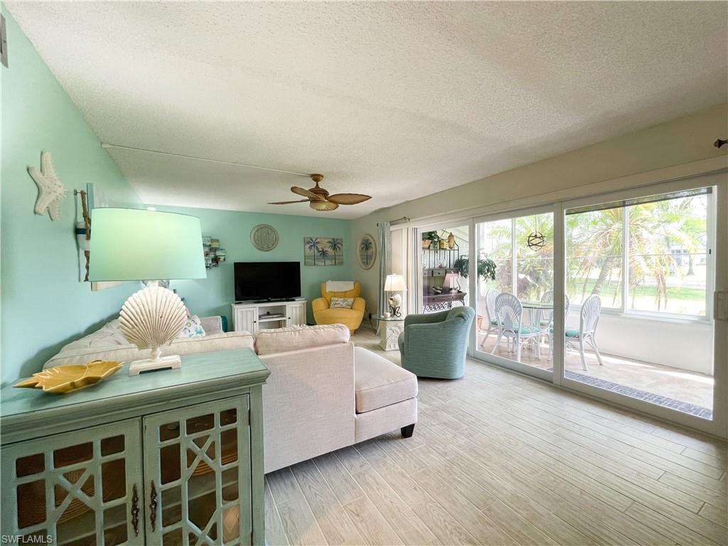 189 Harrison Road, Unit 111 Naples, FL 34112 - Photo 2 of 29 Impact glass shutters and view to the golf course