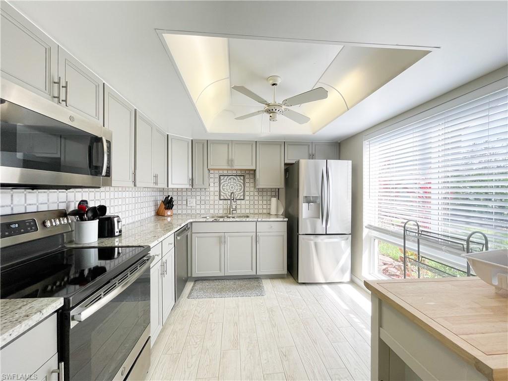189 Harrison Road, Unit 111 Naples, FL 34112 - Photo 3 of 29 Renovated kitchen with stainless appliances and impact glass windows