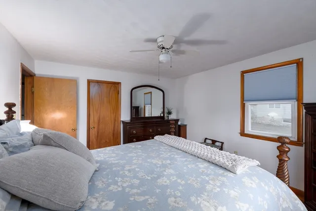 a bedroom with a large bed and a dresser