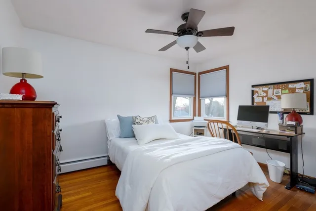 a bedroom with bed tv and window