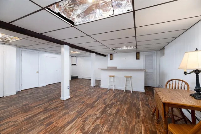 a view of a room with wooden floor wooden floors and windows