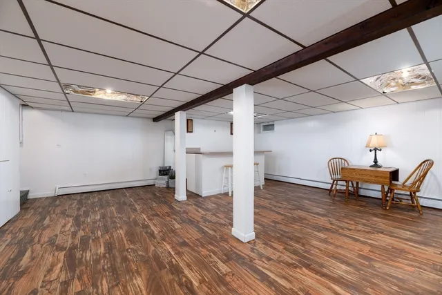 a view of a livingroom with wooden floor and furniture