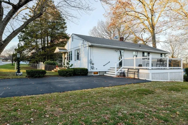 a white house that has a tree in front of it