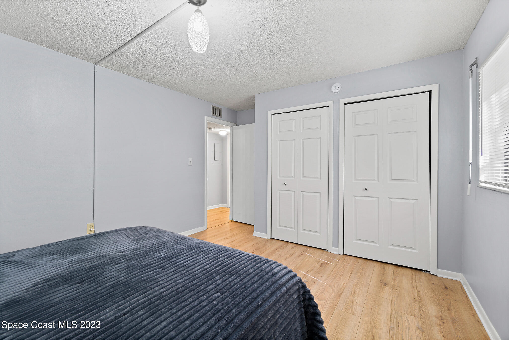 500 Catalina Road, Unit 103 Cocoa Beach, FL 32931 - Photo 16 of 28 a bedroom with a bed and a dresser