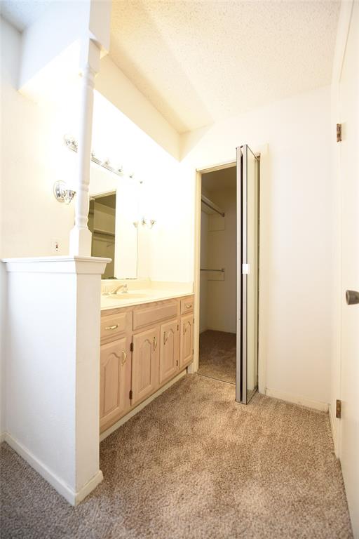 8945 Flicker Lane Dallas, TX 75238 - Photo 12 of 18 a bathroom with a double vanity sink and mirror