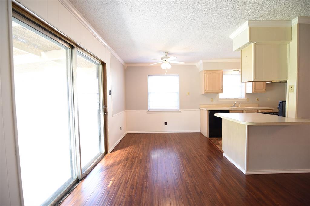 8945 Flicker Lane Dallas, TX 75238 - Photo 4 of 18 a view of a kitchen cabinets a sink and wooden floor