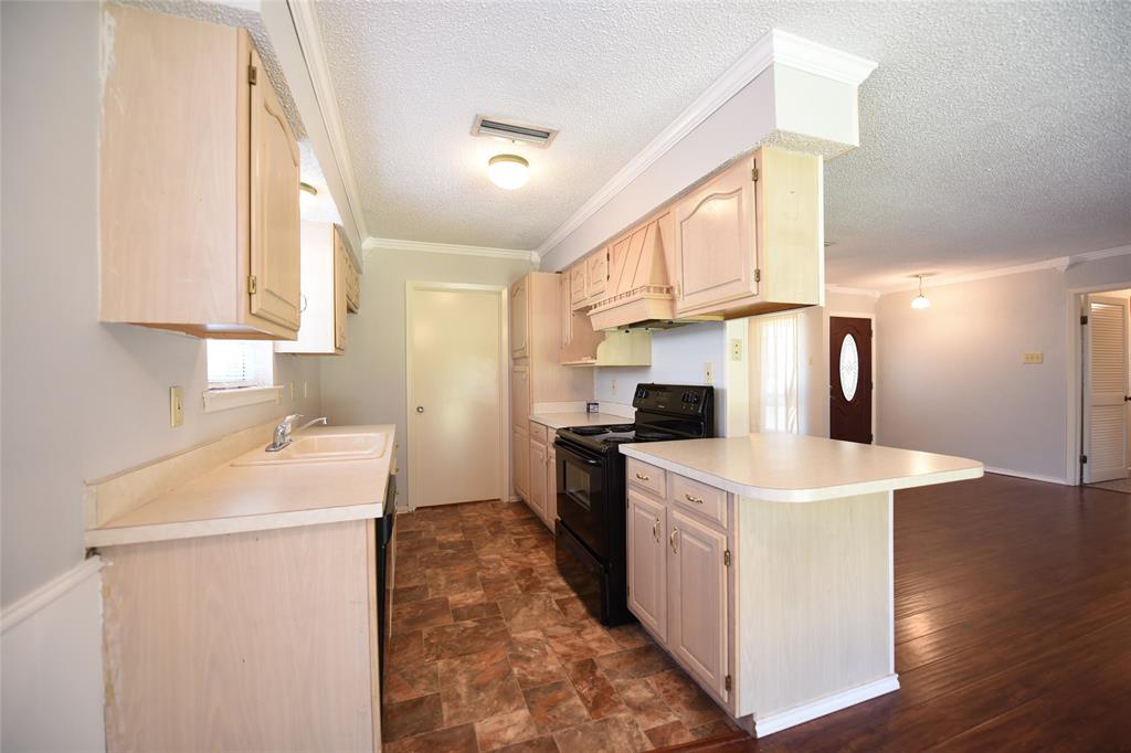 8945 Flicker Lane Dallas, TX 75238 - Photo 5 of 18 a kitchen that has a sink a stove and a refrigerator