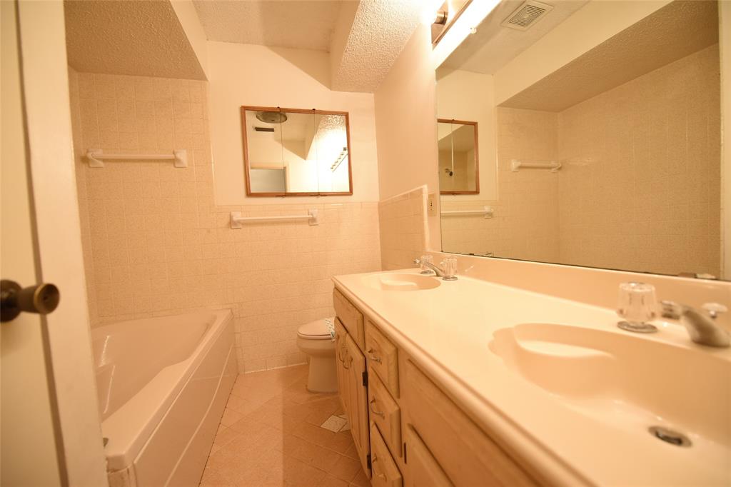 8945 Flicker Lane Dallas, TX 75238 - Photo 10 of 18 a bathroom with a sink and a mirror
