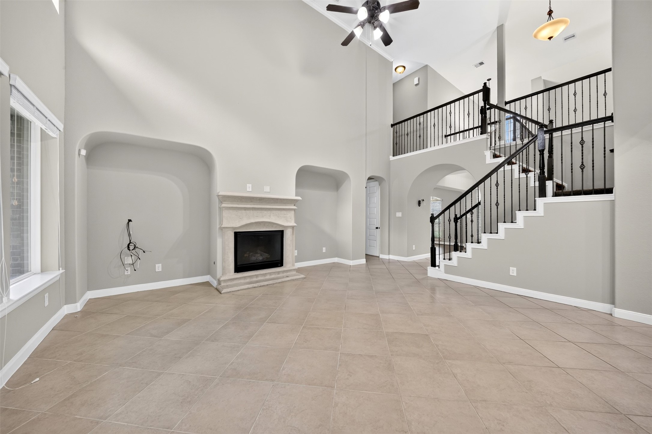 6234 Avon Landing Lane Spring, TX 77379 - Photo 14 of 49 The family room is defined by its stunning cast stone fireplace offering a central focal point, flanked by entertainment wall alcoves.