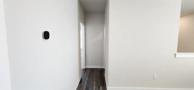 a view of an empty room with closet area
