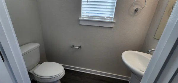 a white toilet sitting next to a window