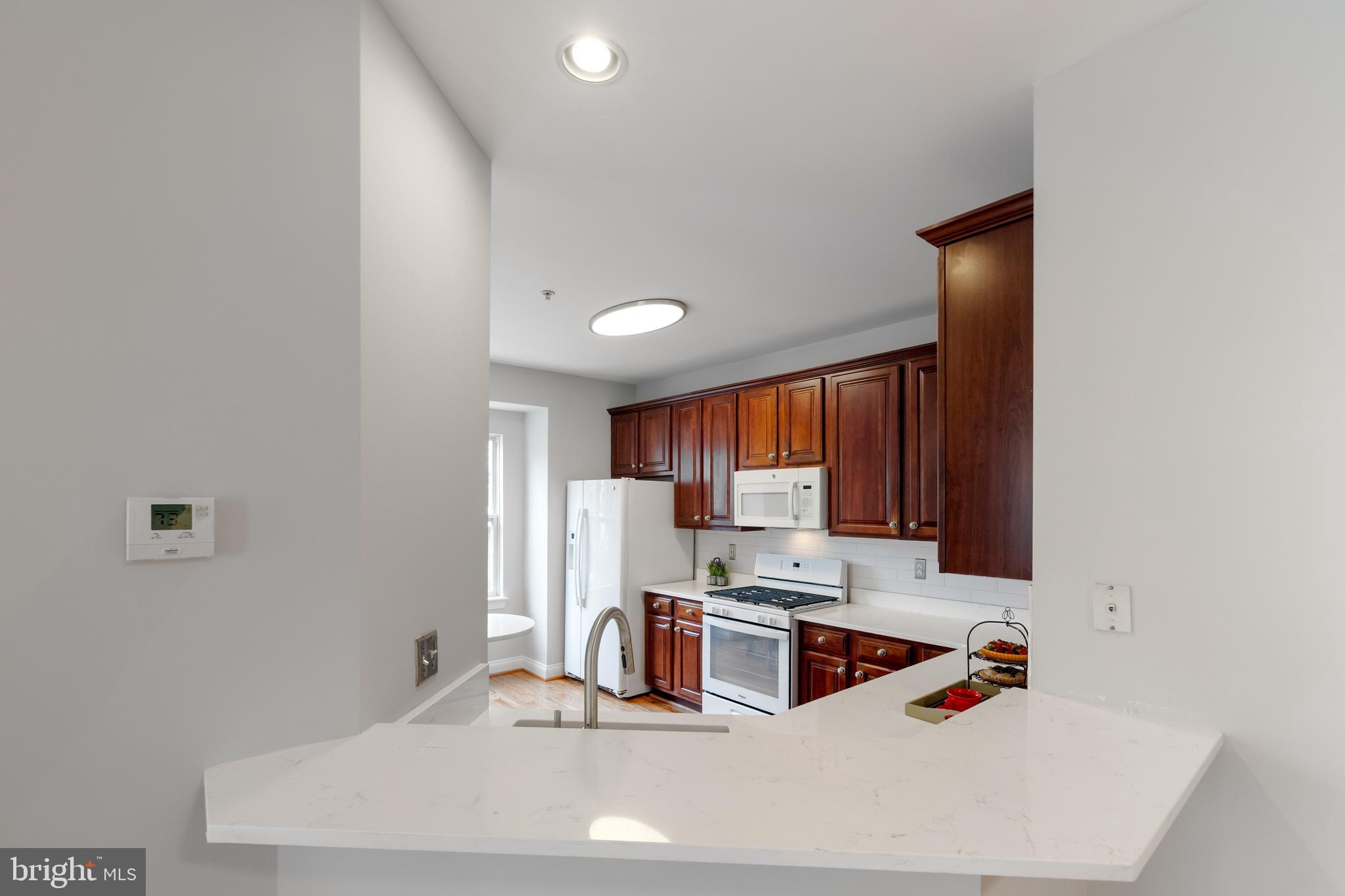 5117 Grimm Drive Alexandria, VA 22304 - Photo 13 of 67 a kitchen with stainless steel appliances a sink a stove a refrigerator and cabinets