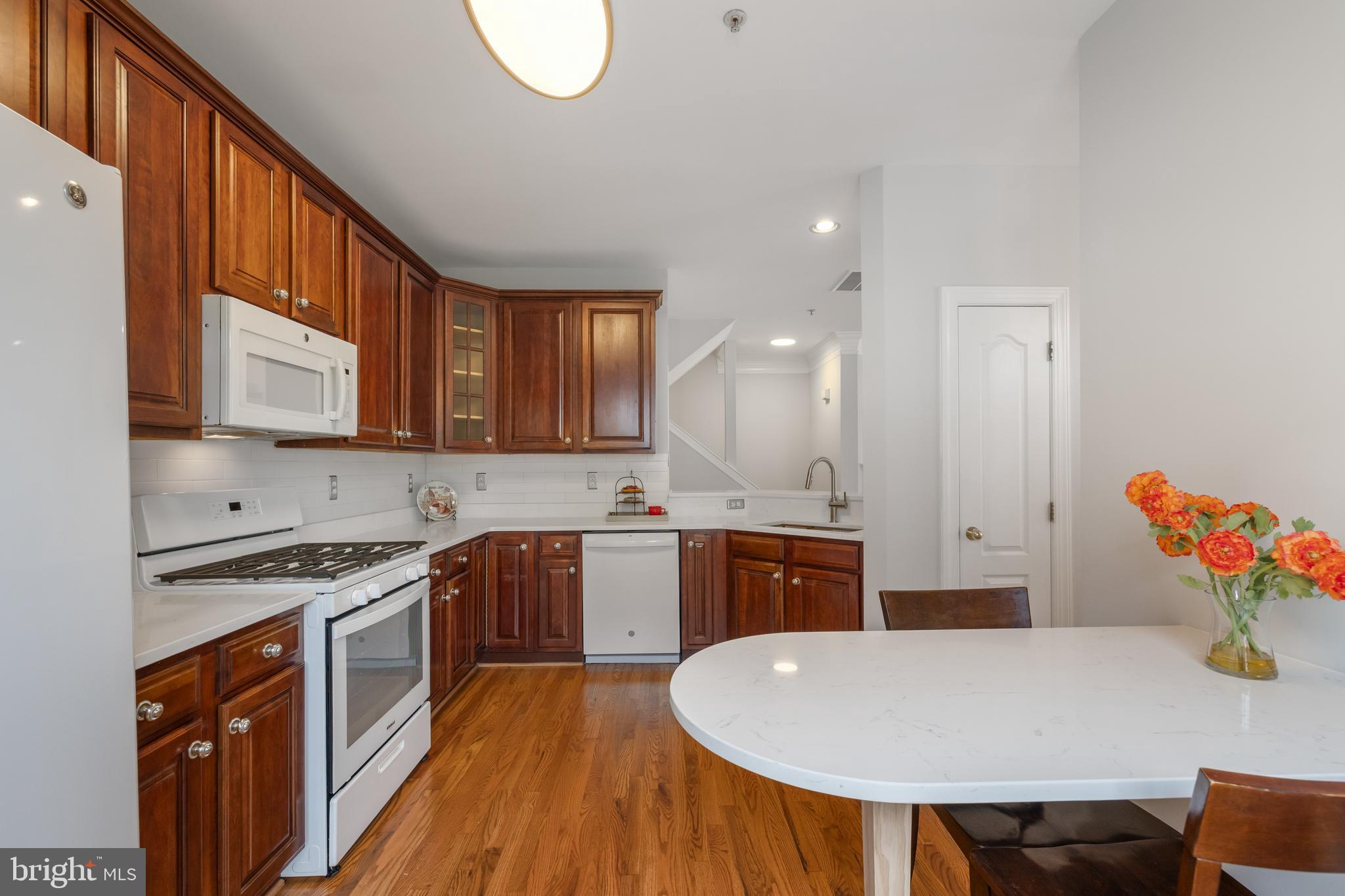 5117 Grimm Drive Alexandria, VA 22304 - Photo 16 of 67 a kitchen with stainless steel appliances granite countertop a stove a sink dishwasher and a refrigerator with wooden floor