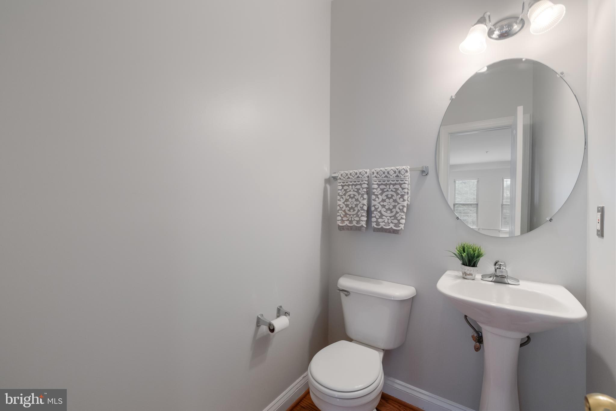 5117 Grimm Drive Alexandria, VA 22304 - Photo 21 of 67 a bathroom with a toilet sink and mirror