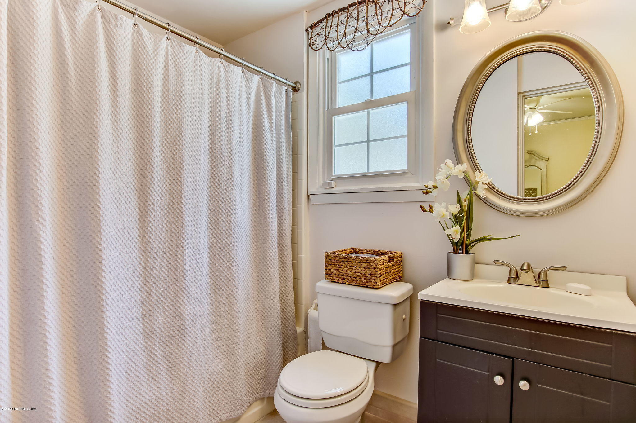 2164 Huntsford Road Jacksonville, FL 32207 - Photo 19 of 34 a bathroom with a toilet a sink and a mirror