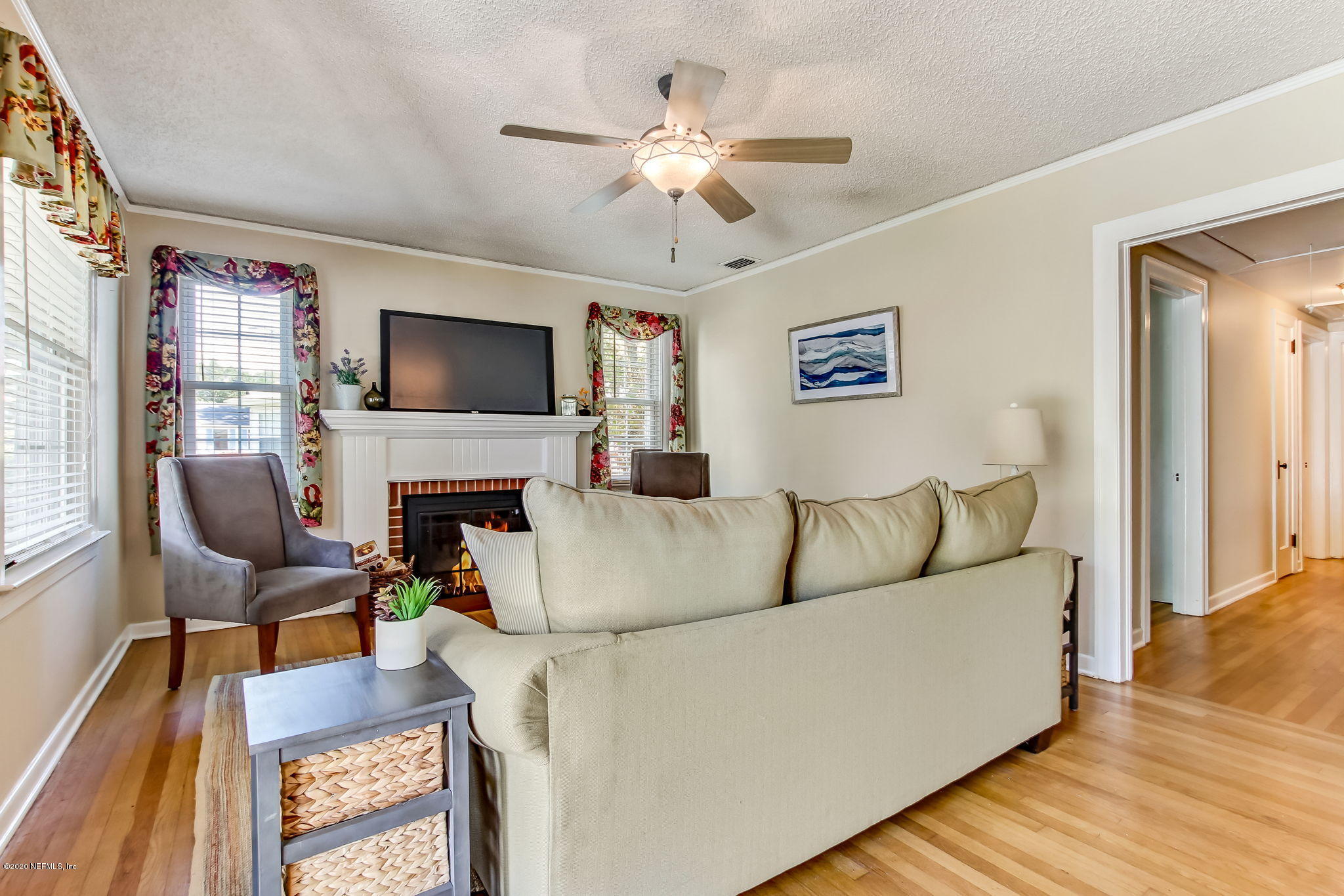 2164 Huntsford Road Jacksonville, FL 32207 - Photo 8 of 34 a living room with furniture a fireplace and a flat screen tv