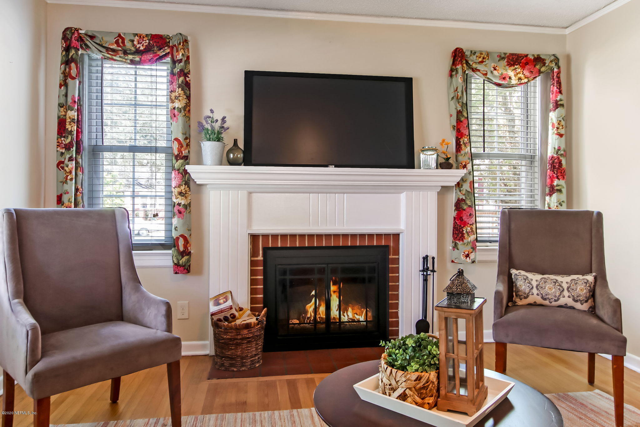 2164 Huntsford Road Jacksonville, FL 32207 - Photo 9 of 34 a living room with furniture a flat screen tv and a fireplace