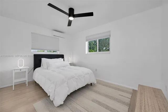 a bedroom with a bed and a painting on the wall