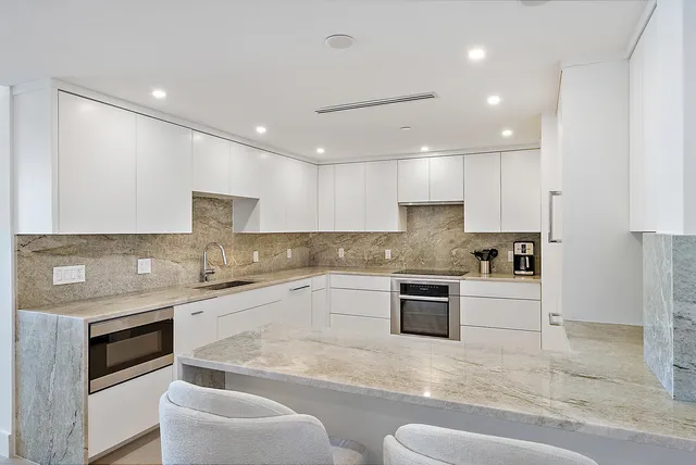 a living room with furniture large window and a table