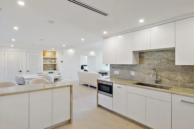 a living room with furniture and large windows