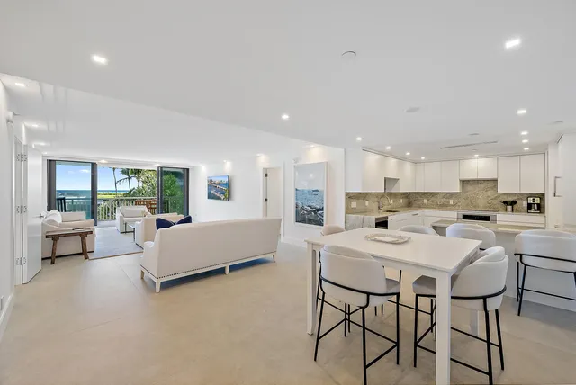 a bedroom with a bed and large windows