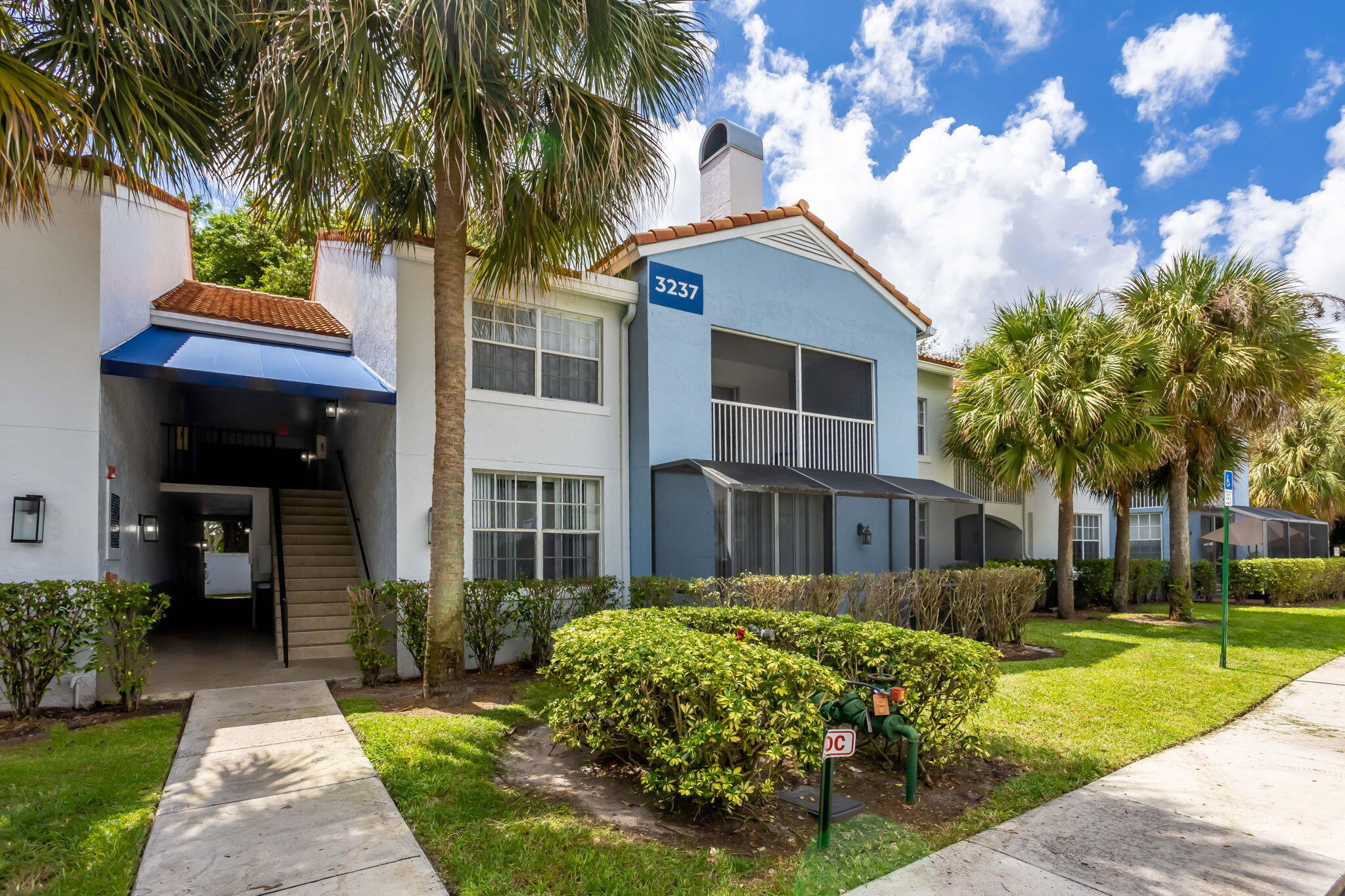 3237 Clint Moore Road, Unit 103 Boca Raton, FL 33496 - Photo 13 of 13 a front view of a house with garden