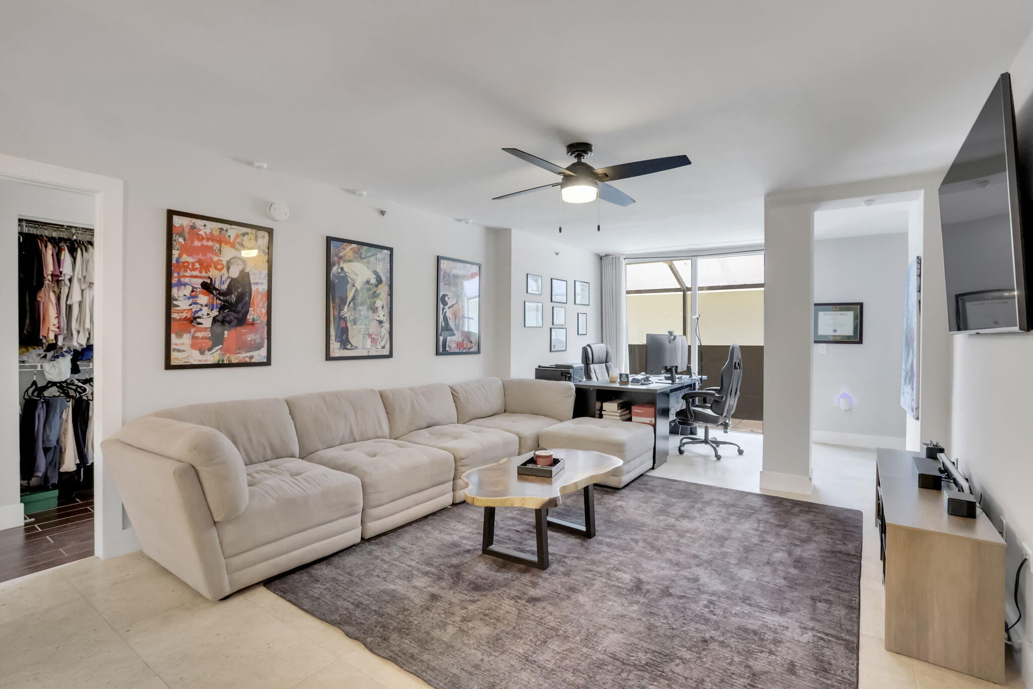 3237 Clint Moore Road, Unit 103 Boca Raton, FL 33496 - Photo 3 of 13 a living room with furniture a large window and a flat screen tv