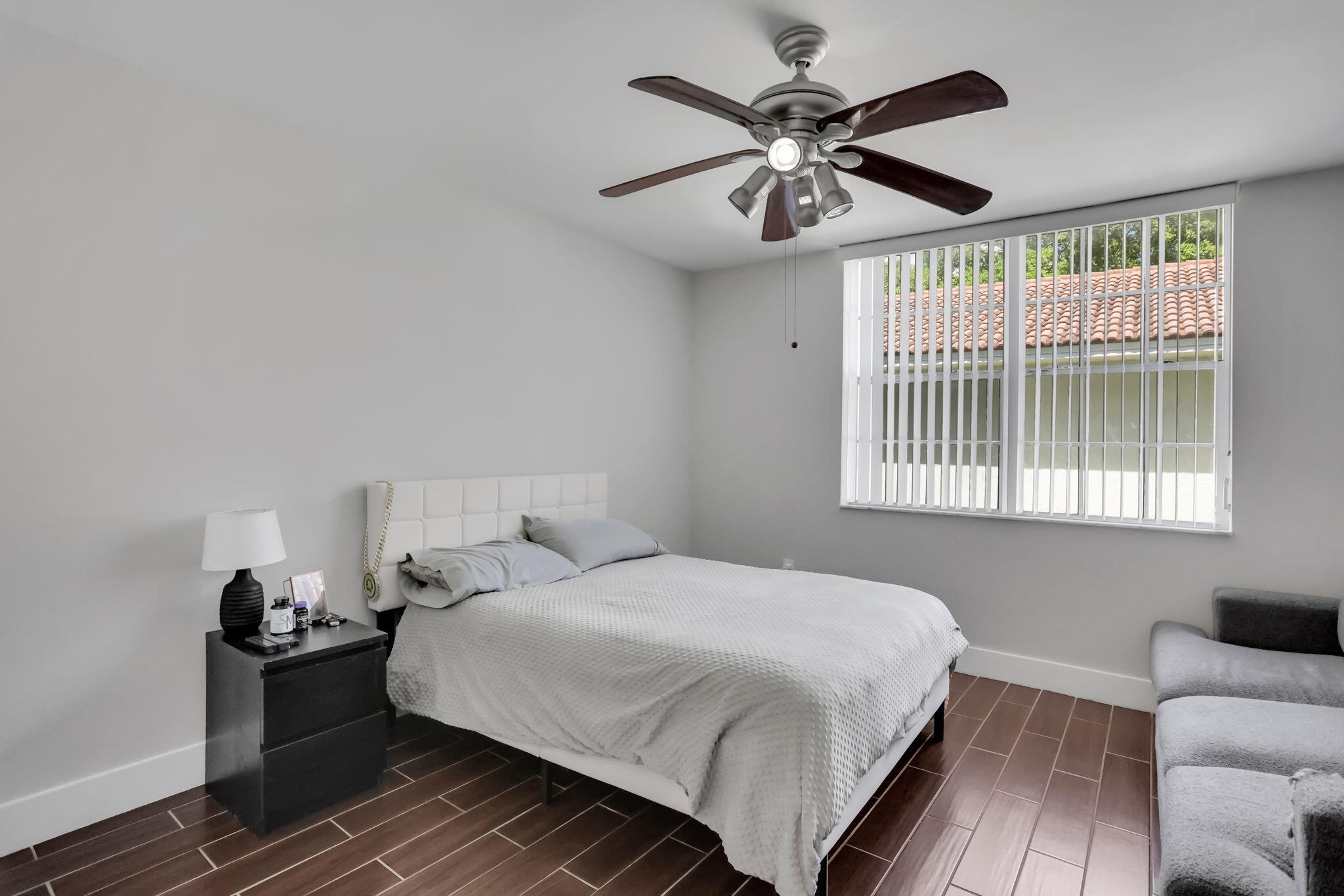 3237 Clint Moore Road, Unit 103 Boca Raton, FL 33496 - Photo 7 of 13 a bedroom with a bed and a window