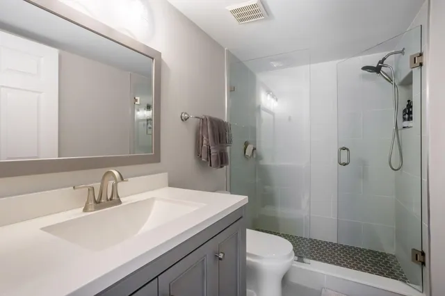 a bathroom with a sink toilet and shower