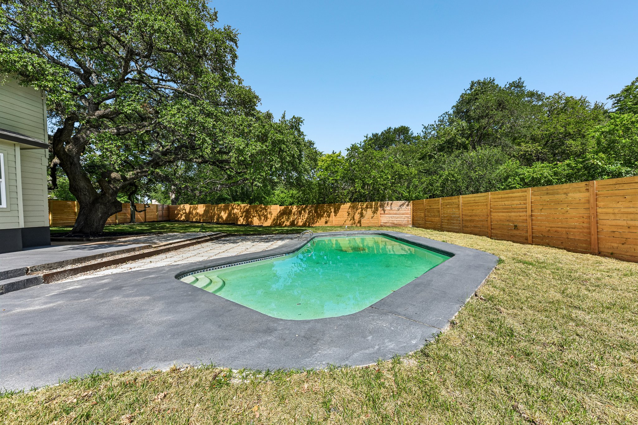 7523 Glenhill Road Austin, TX 78752 - Photo 36 of 38 An inviting backyard oasis offers a sparkling pool for warm weather enjoyment.