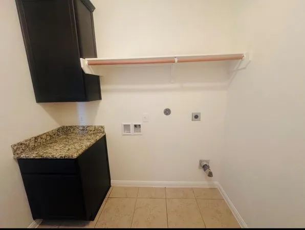 a kitchen with stainless steel appliances a sink a stove top oven a counter space and cabinets