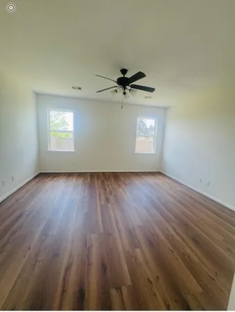 a view of a closet with wooden floor