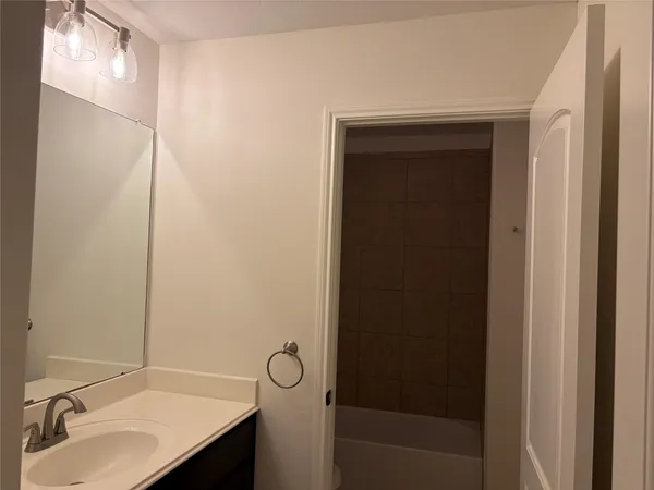 a bathroom with a bathtub and a sink