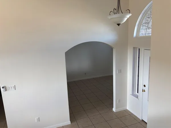 a kitchen with granite countertop a refrigerator and a stove top oven