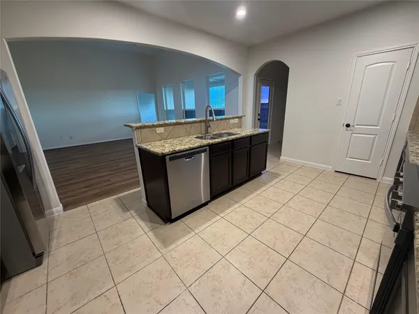 a kitchen with stainless steel appliances granite countertop a sink and a stove