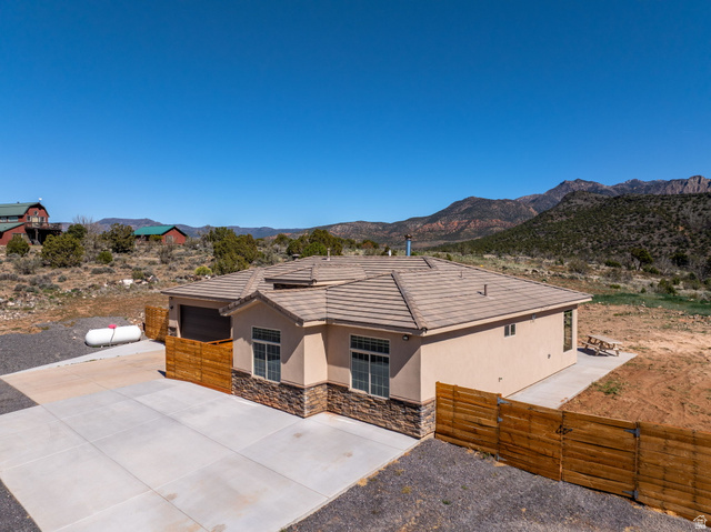 62 North Lucky 7 Road Veyo, UT 84782 - Photo 38 of 43 Single story home featuring a gate, a mountain view, stucco siding, stone siding, and a tiled roof