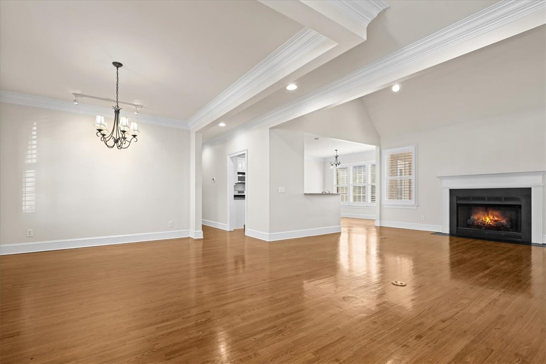 38 Angus Run Seneca, SC 29672 - Photo 6 of 46 This living space features warm hardwood floors and a cozy fireplace, perfect for relaxation and gatherings.