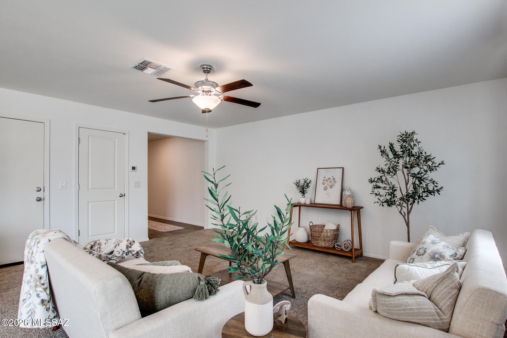 5987 South Antrim Loop Tucson, AZ 85706 - Photo 10 of 34 a living room with furniture and a chandelier