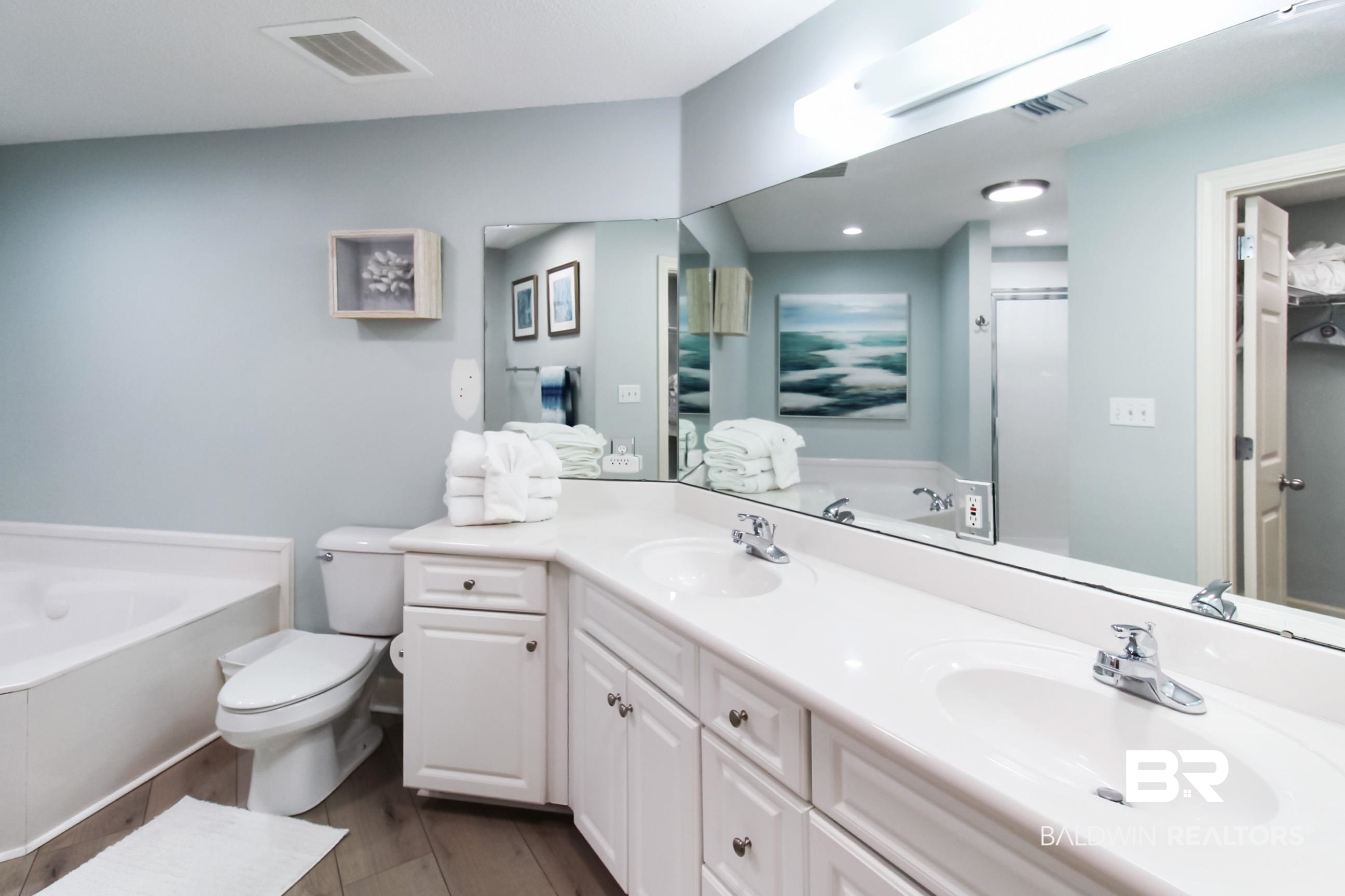 27580 Canal Road, Unit 1425 Orange Beach, AL 36561 - Photo 15 of 28 Full bath featuring a bath, double vanity, wood finished floors, and an enclosed shower