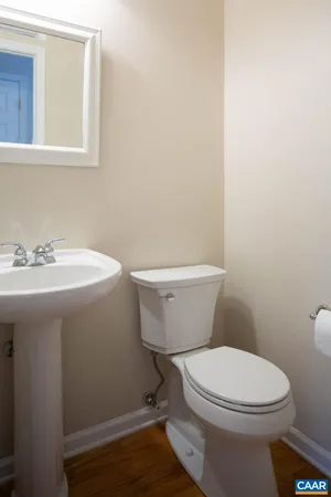 a white toilet sitting next to a white sink