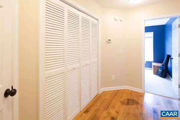 a view of a bedroom with a bed and a window