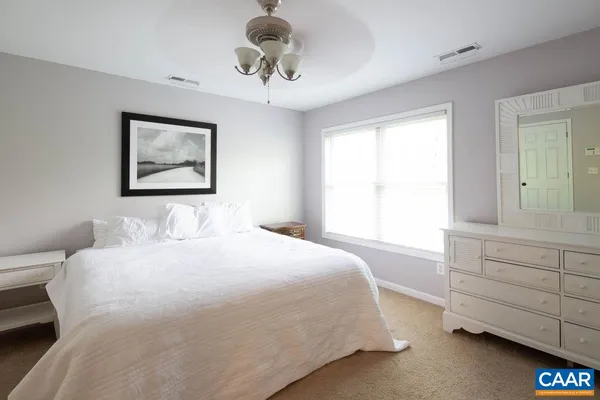 a bedroom with a bed and a dresser