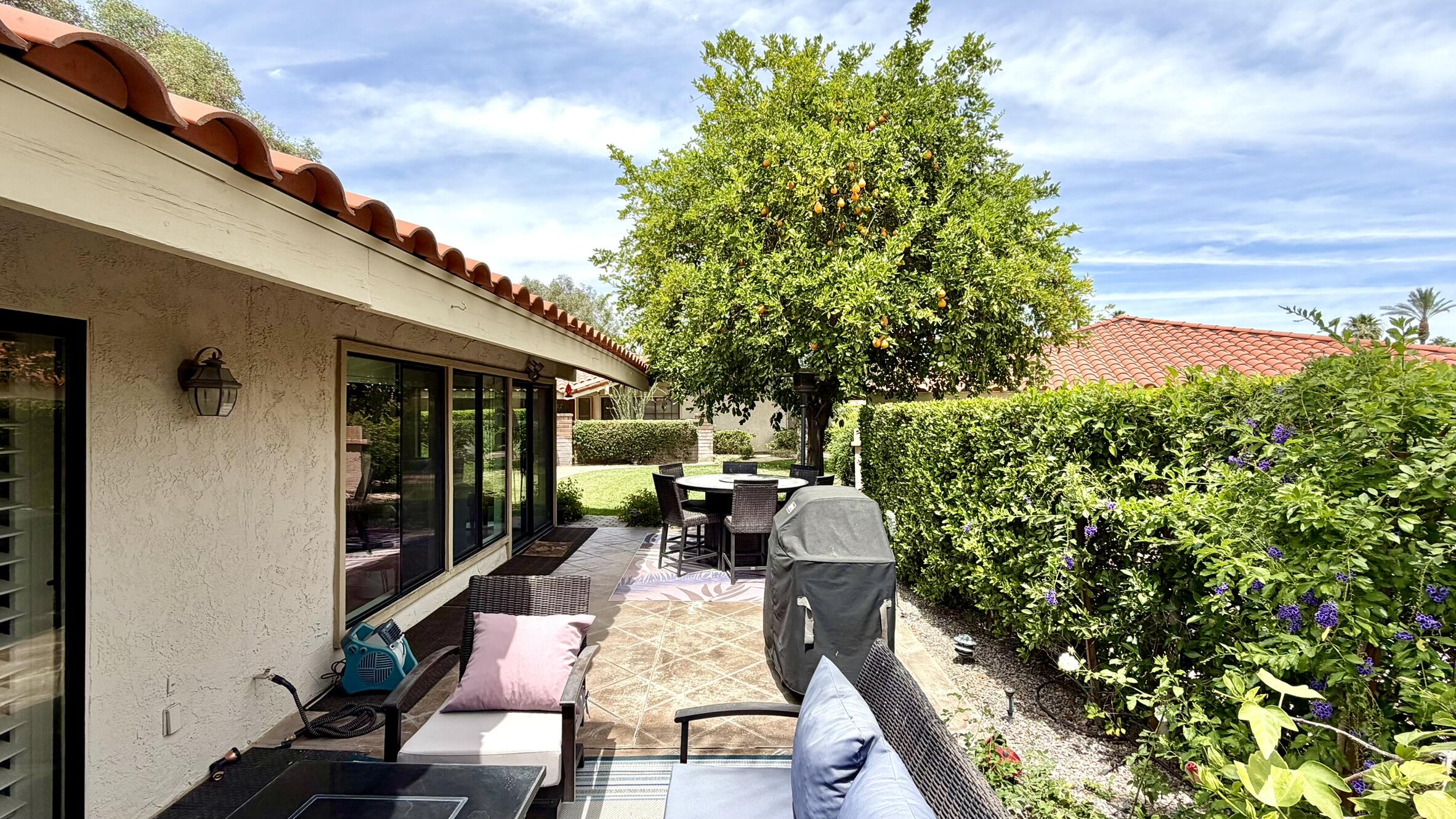 45740 Pueblo Road Indian Wells, CA 92210 - Photo 32 of 61 a view of a patio with table and chairs and potted plants